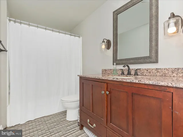 a front view of a house with a garden and trees