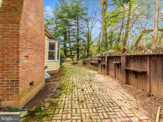 a backyard of a house with barbeque oven and outdoor seating
