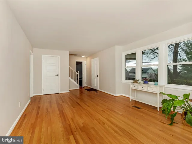 a view of a livingroom with wooden floor and furniture