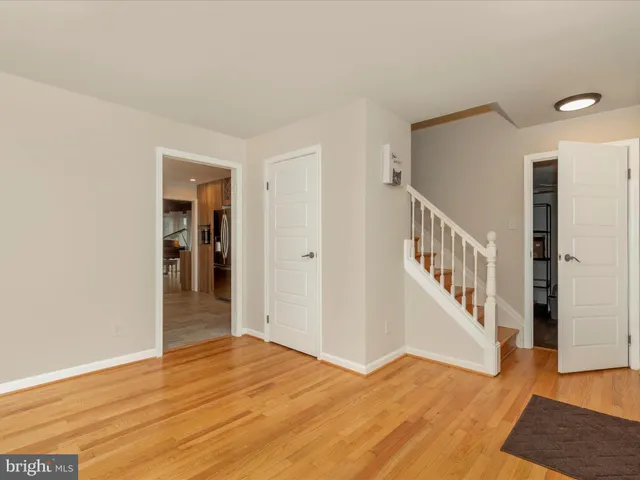 a view of an entryway with wooden floor and door