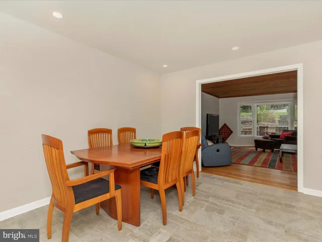a view of a dining room with furniture and a potted plant