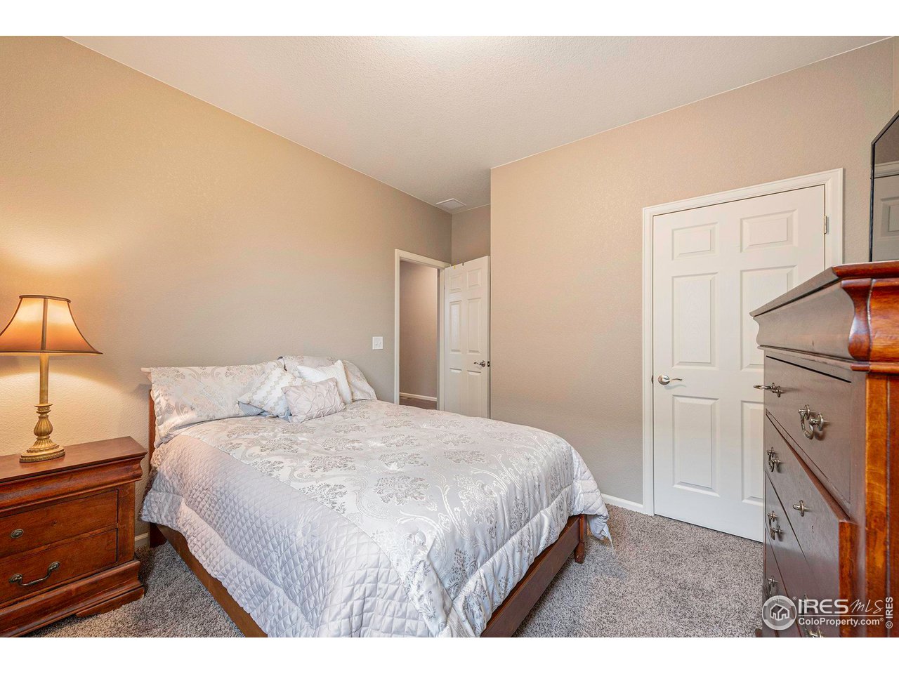 7005 Morrison Drive Frederick, CO 80530 - Photo 14 of 26 a bedroom with a bed and a night stand