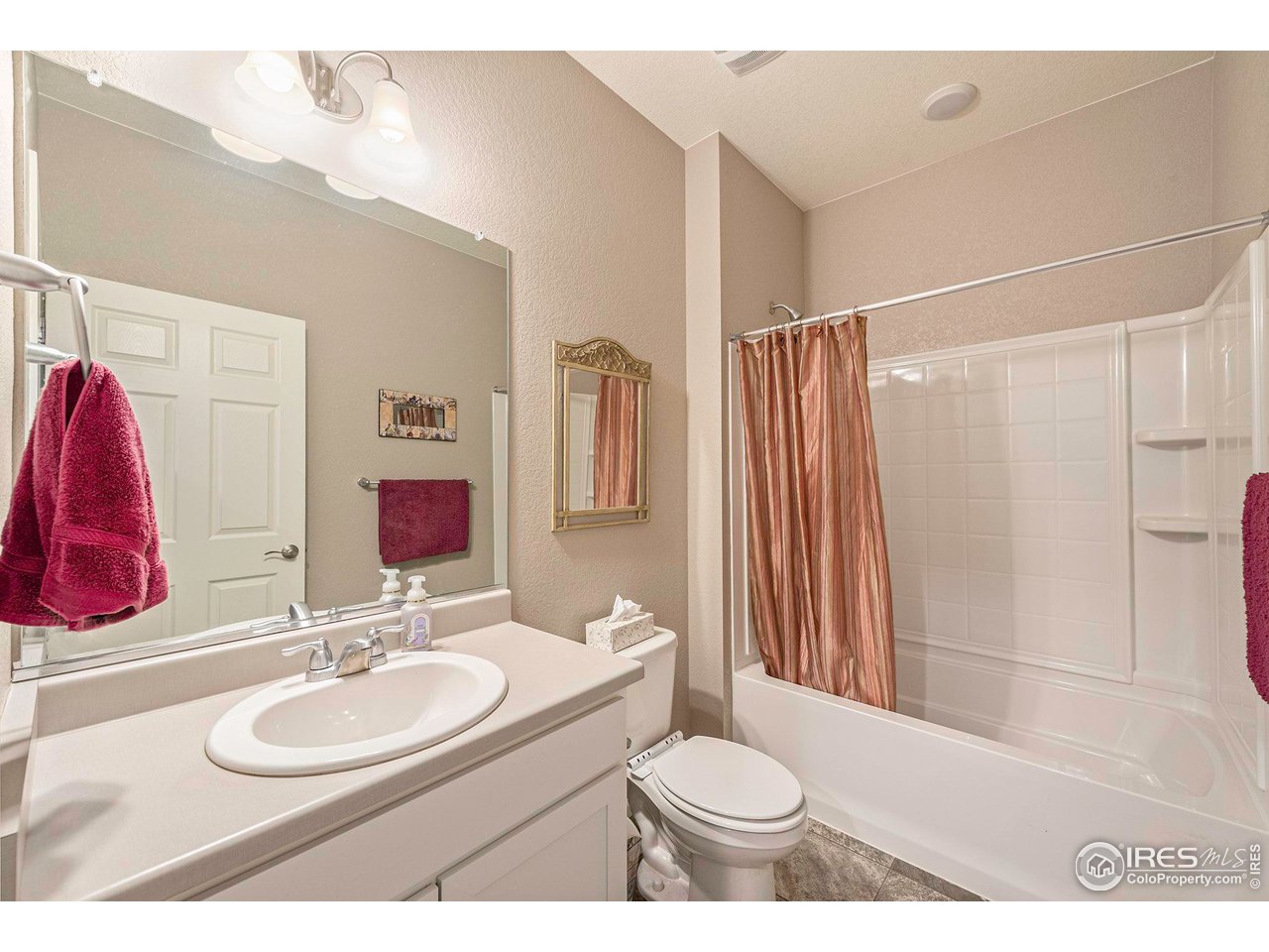 7005 Morrison Drive Frederick, CO 80530 - Photo 15 of 26 a bathroom with a sink toilet and shower