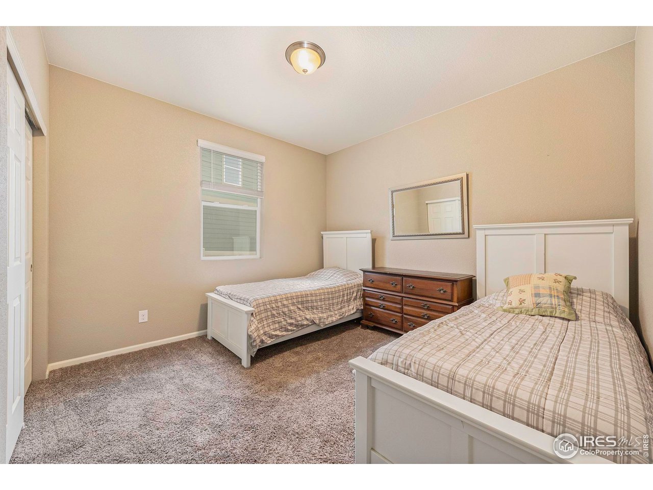 7005 Morrison Drive Frederick, CO 80530 - Photo 16 of 26 a bedroom with a bed and a night stand