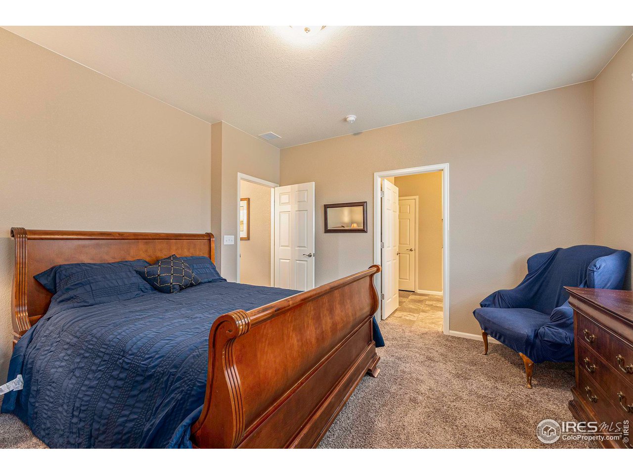 7005 Morrison Drive Frederick, CO 80530 - Photo 17 of 26 a bedroom with furniture and a wooden floor