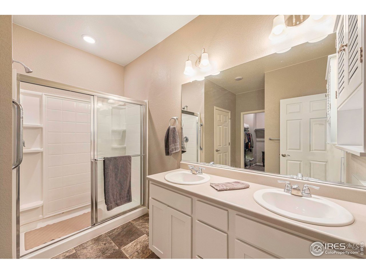 7005 Morrison Drive Frederick, CO 80530 - Photo 19 of 26 a bathroom with a sink double vanity and a shower