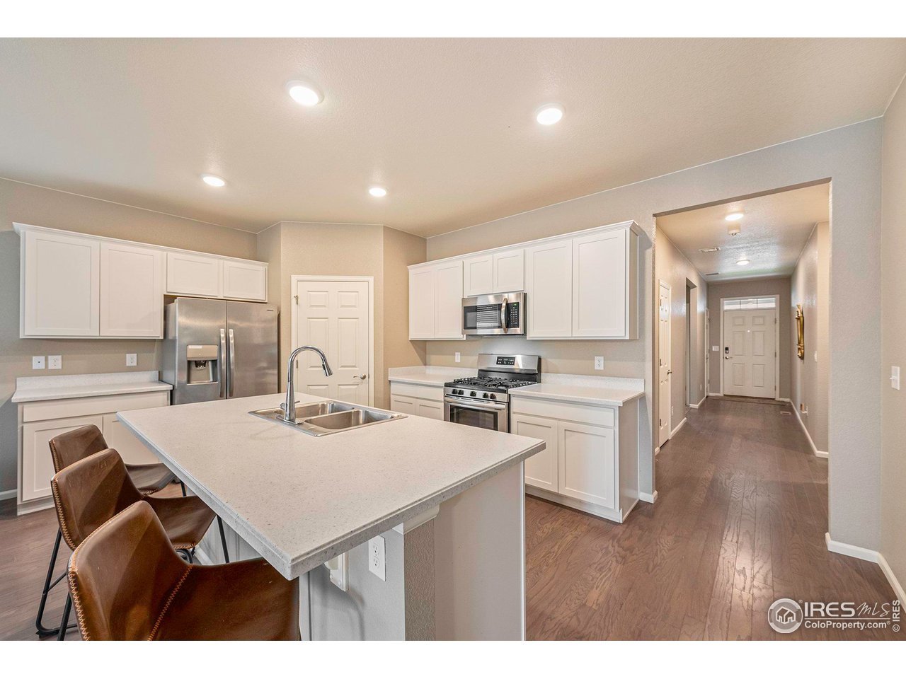 7005 Morrison Drive Frederick, CO 80530 - Photo 6 of 26 a kitchen with a table and chairs
