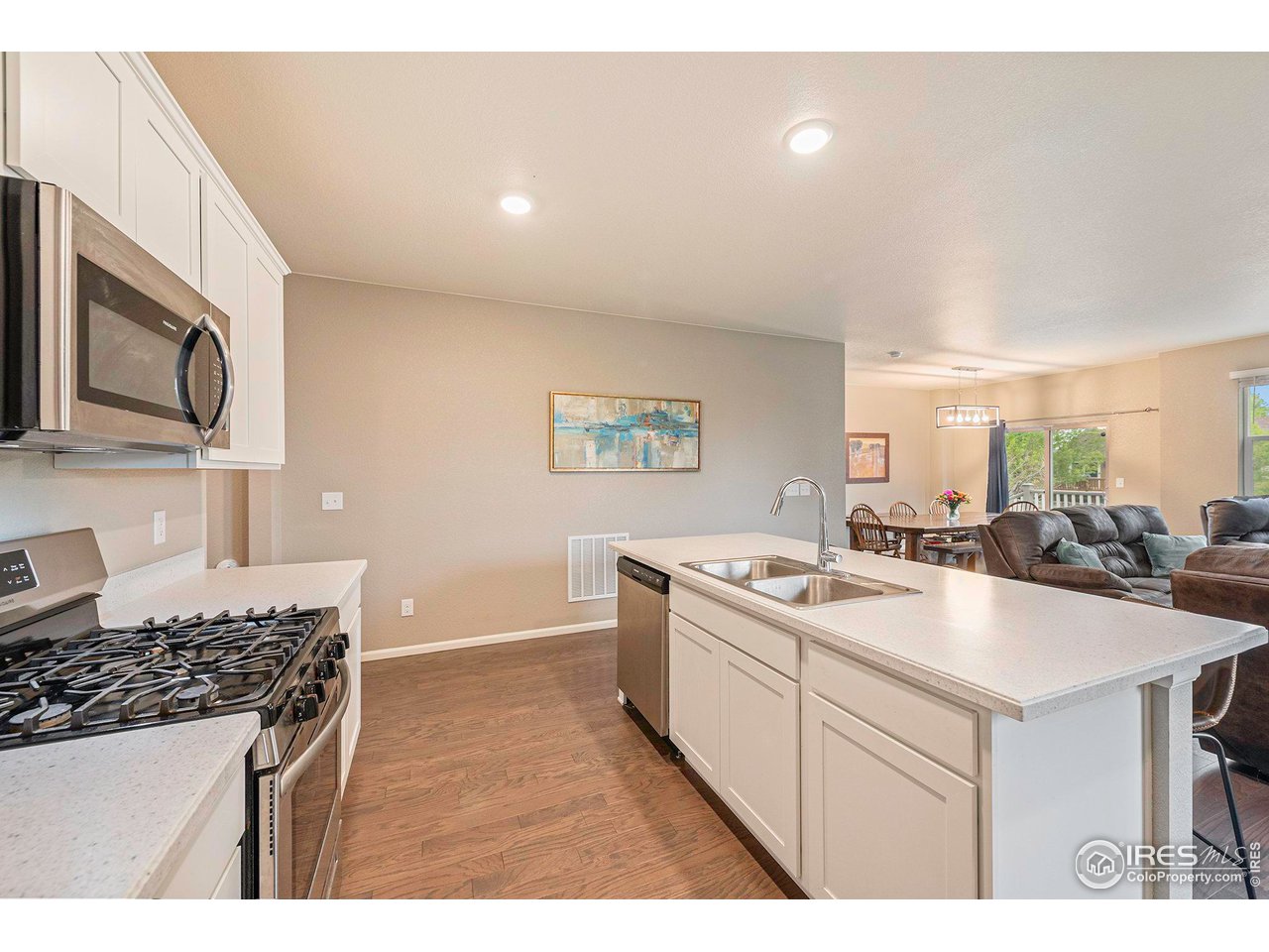 7005 Morrison Drive Frederick, CO 80530 - Photo 7 of 26 a kitchen with a sink a stove top oven a counter space and cabinets