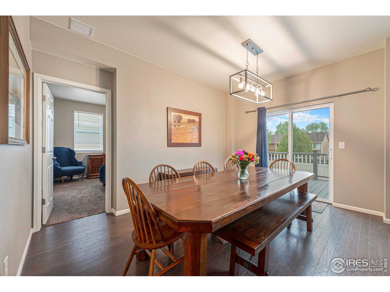 7005 Morrison Drive Frederick, CO 80530 - Photo 9 of 26 a view of a dining room with furniture wooden floor and a chandelier