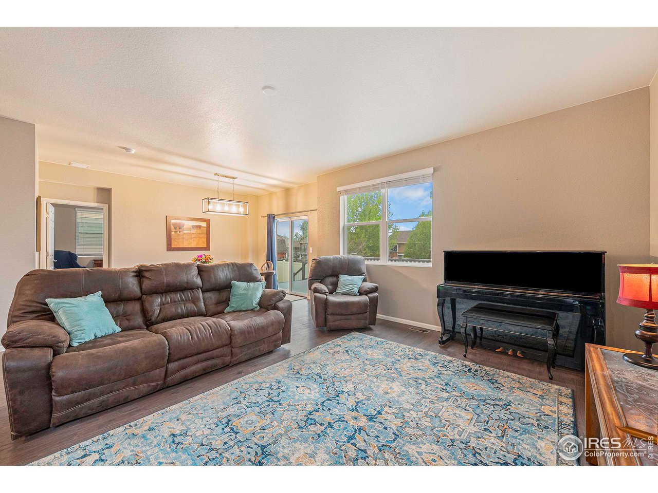 7005 Morrison Drive Frederick, CO 80530 - Photo 10 of 26 a living room with furniture and a flat screen tv
