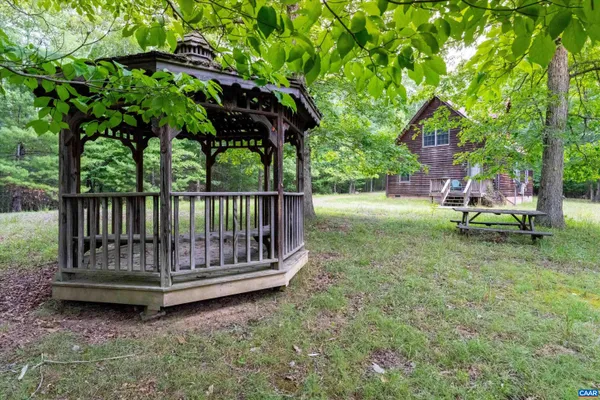 a view of backyard with a swing