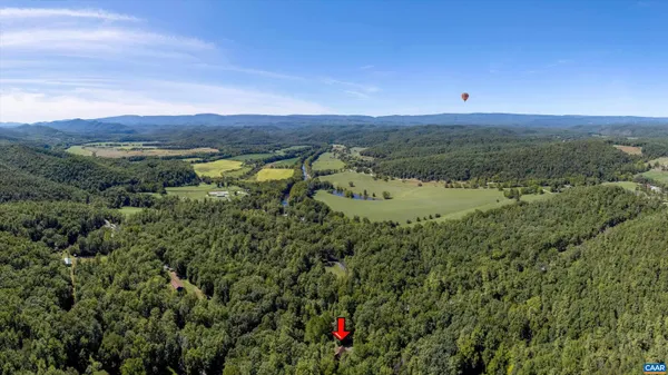 a view of a field with an ocean