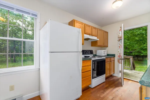 a kitchen with stainless steel appliances granite countertop a refrigerator sink and stove