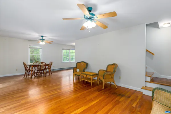 a view of a dining room with furniture and wooden floor