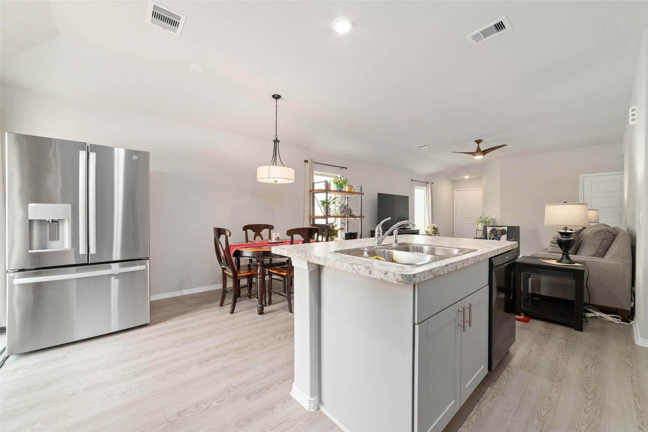 14232 Shasta Ridge Drive Conroe, TX 77303 - Photo 8 of 26 View from the kitchen showcasing the open layout, with high ceilings and natural light carrying through to the living and dining areas for a connected feel.