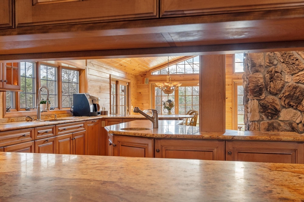 243 Concord Road Westford, MA 01886 - Photo 15 of 42 a large kitchen with stainless steel appliances wooden cabinets and a counter top space