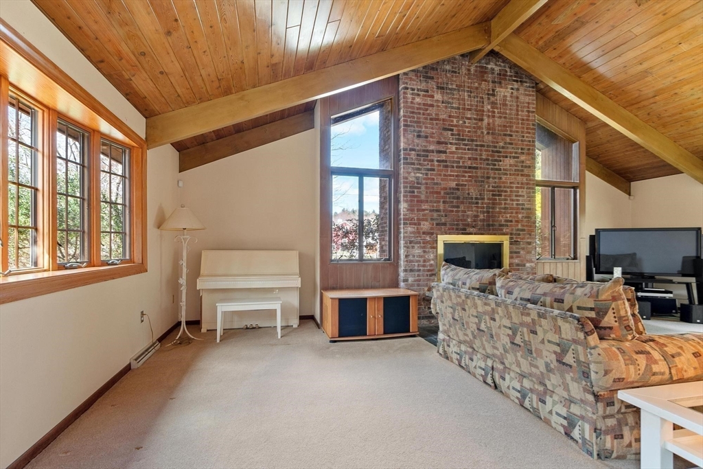 243 Concord Road Westford, MA 01886 - Photo 17 of 42 a living room with furniture and a flat screen tv