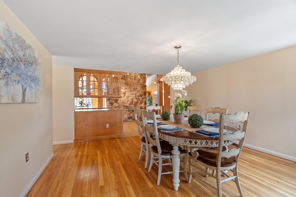 243 Concord Road Westford, MA 01886 - Photo 19 of 42 a dining room with furniture a chandelier and wooden floor