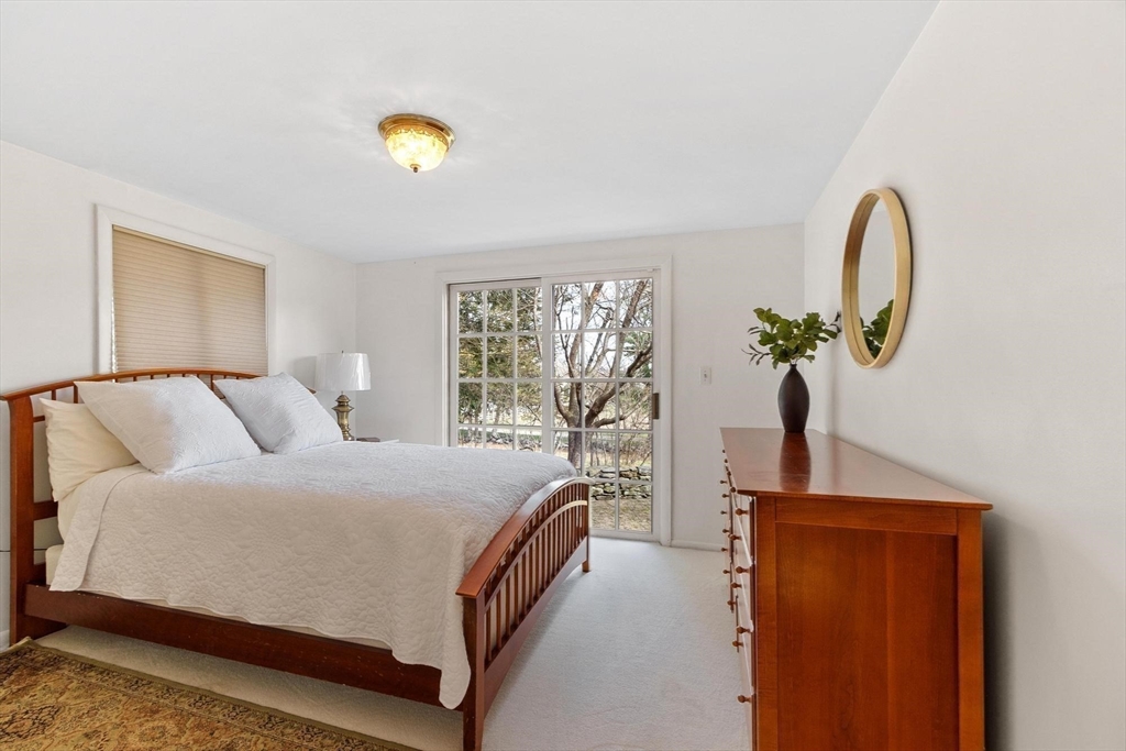 243 Concord Road Westford, MA 01886 - Photo 21 of 42 a bedroom with a bed and a potted plant