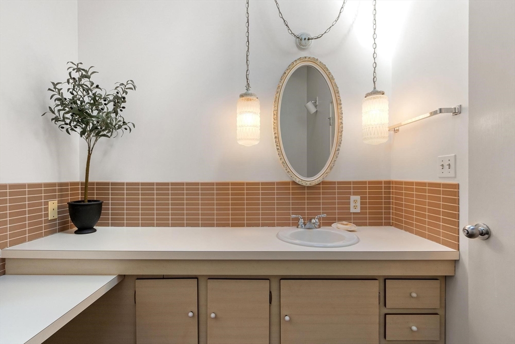 243 Concord Road Westford, MA 01886 - Photo 24 of 42 a bathroom with a sink and a mirror