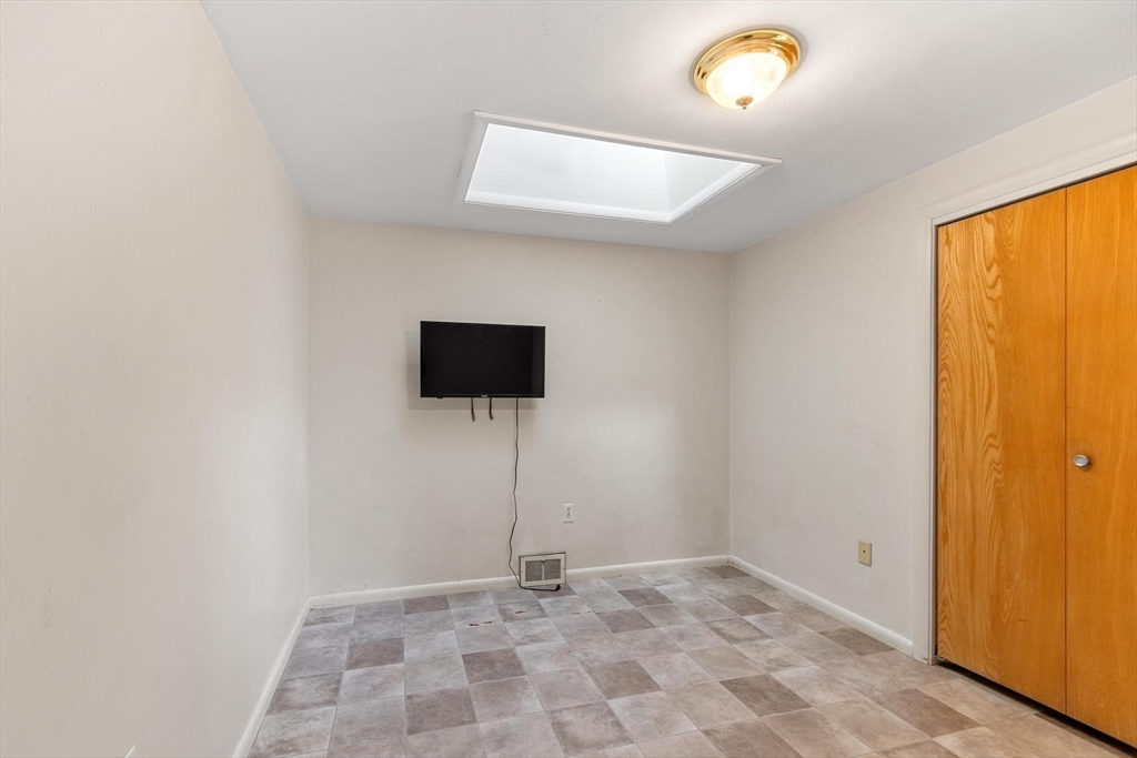 243 Concord Road Westford, MA 01886 - Photo 25 of 42 a view of an empty room with a window and a ceiling fan