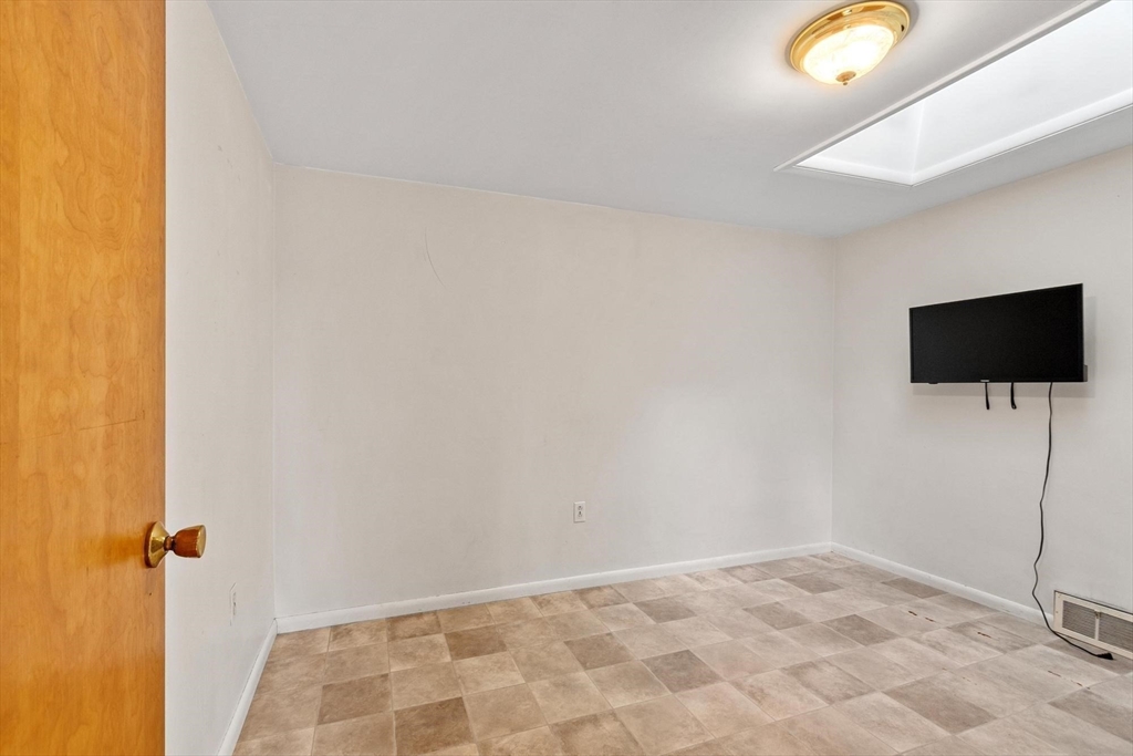 243 Concord Road Westford, MA 01886 - Photo 26 of 42 a view of a livingroom with wooden floor and a flat screen tv