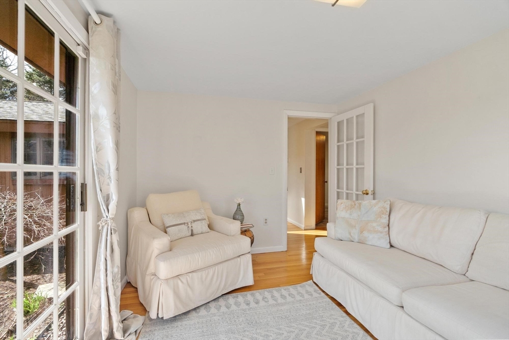 243 Concord Road Westford, MA 01886 - Photo 27 of 42 a living room with furniture and a fireplace