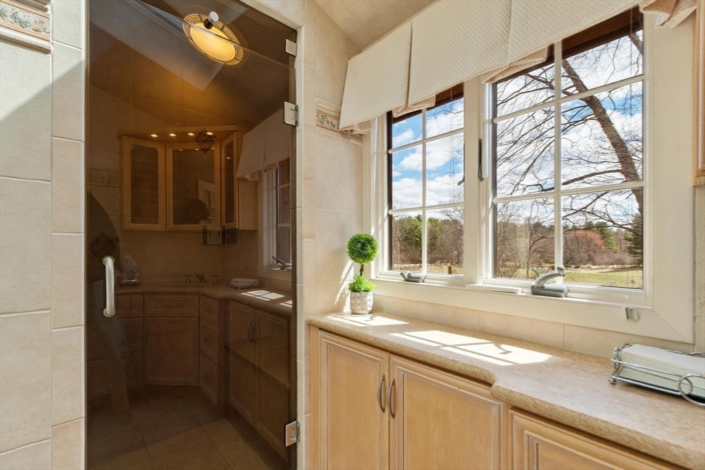 243 Concord Road Westford, MA 01886 - Photo 30 of 42 a bathroom with a granite countertop sink and a large mirror