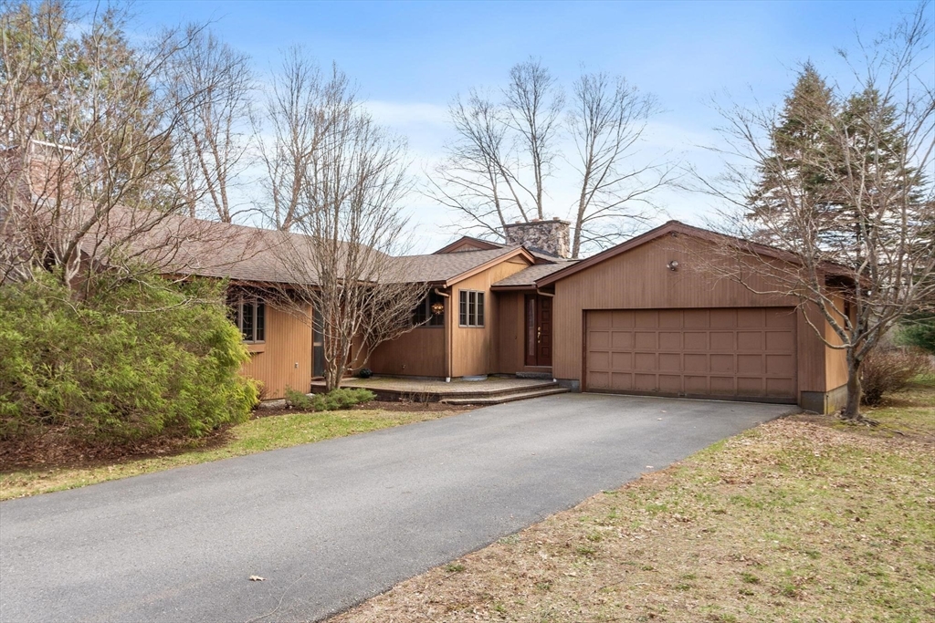 243 Concord Road Westford, MA 01886 - Photo 3 of 42 a front view of a house with a yard and garage