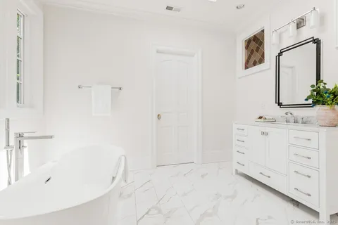 a bathroom with a sink double vanity and tub