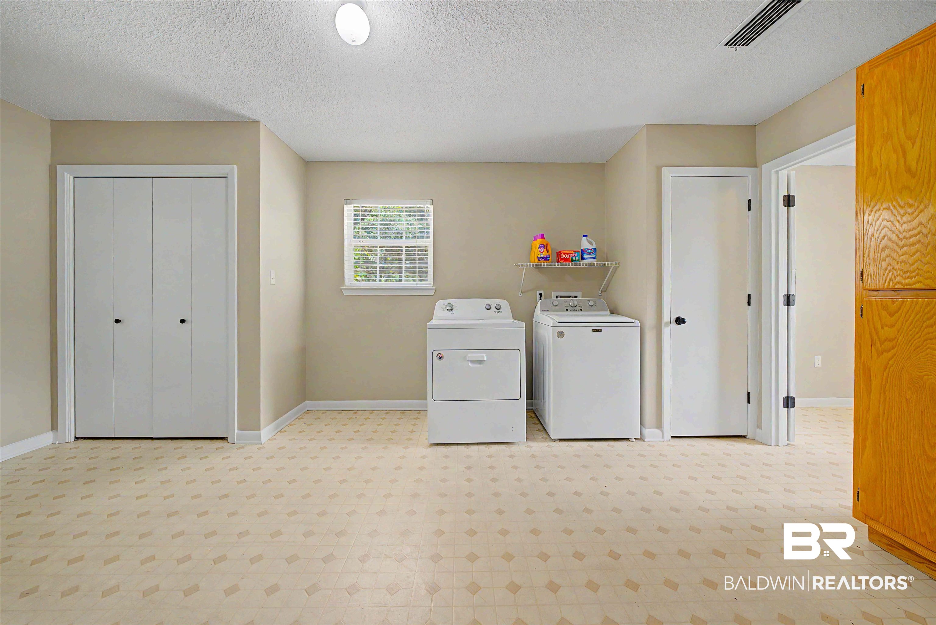 22963 Highway 98 Foley, AL 36535 - Photo 30 of 52 Utility room featuring patterned flooring, bi-fold closet doors, a single window with blinds, and recessed lighting