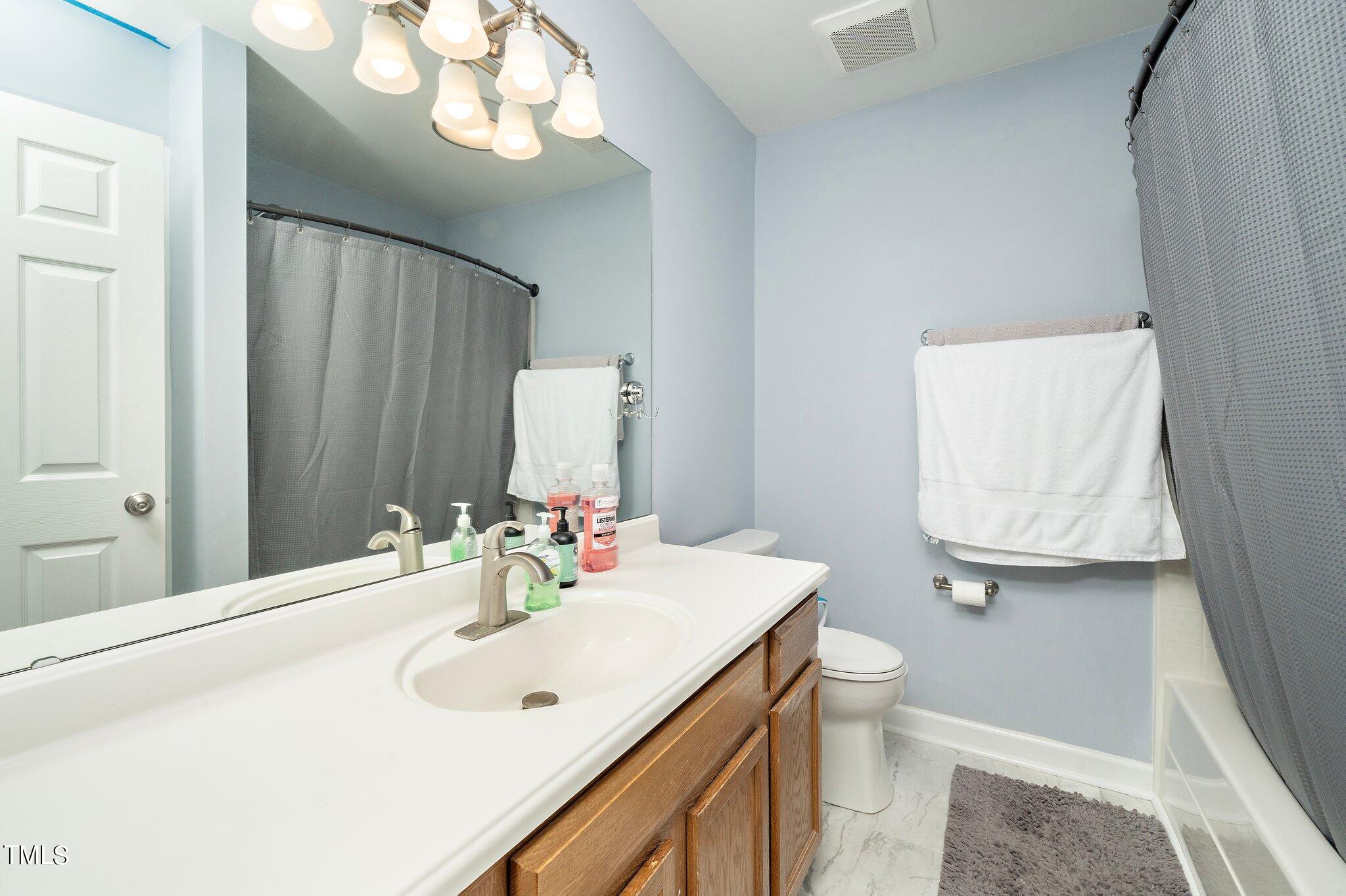 4602 Centrebrook Circle Raleigh, NC 27616 - Photo 15 of 24 a bathroom with a sink a toilet and mirror