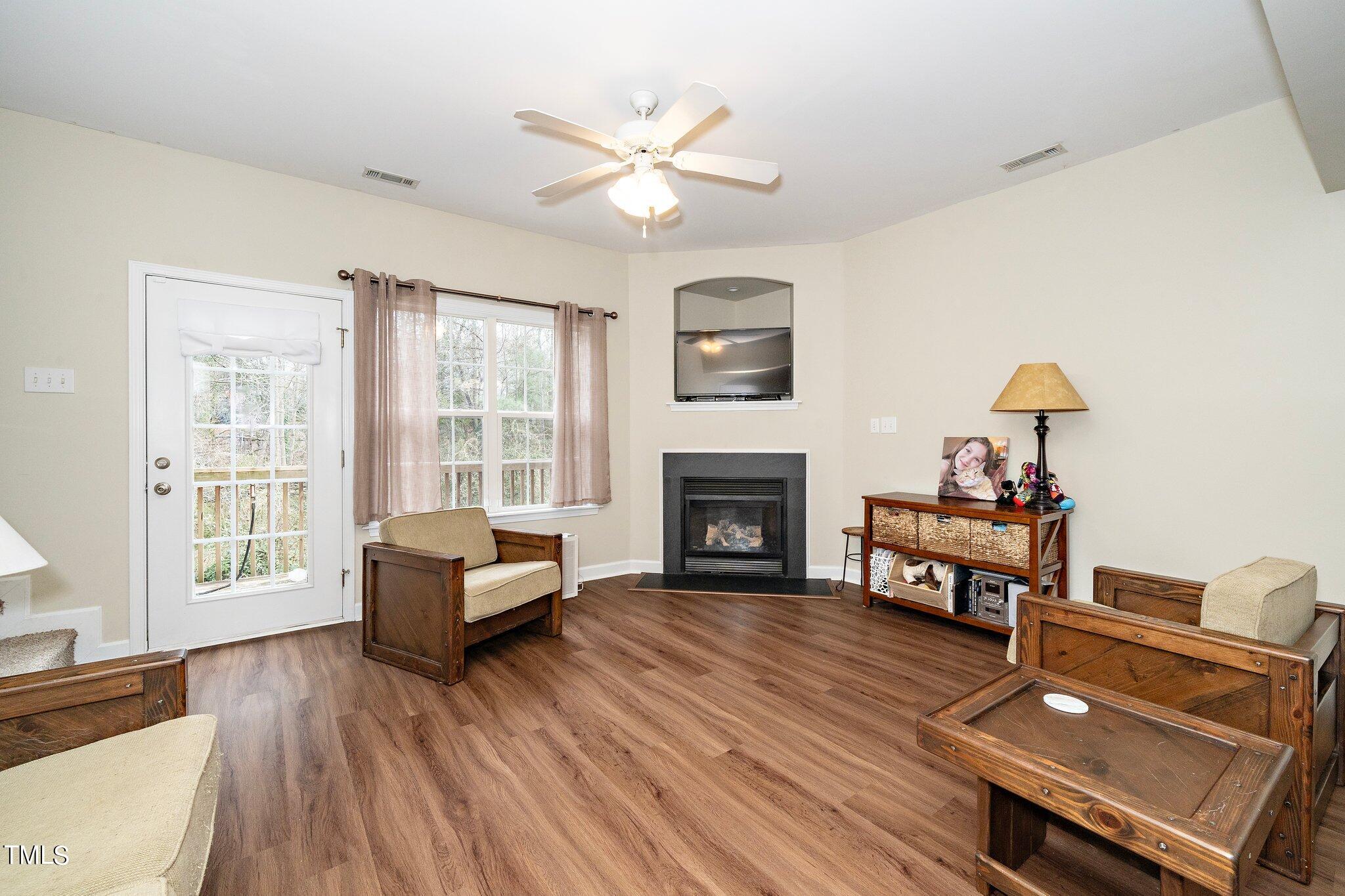 4602 Centrebrook Circle Raleigh, NC 27616 - Photo 6 of 24 a living room with furniture and a fireplace
