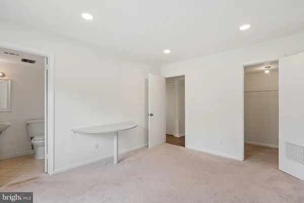 a view of an empty room and a bathroom
