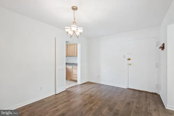 a view of a chandelier fan and entryway
