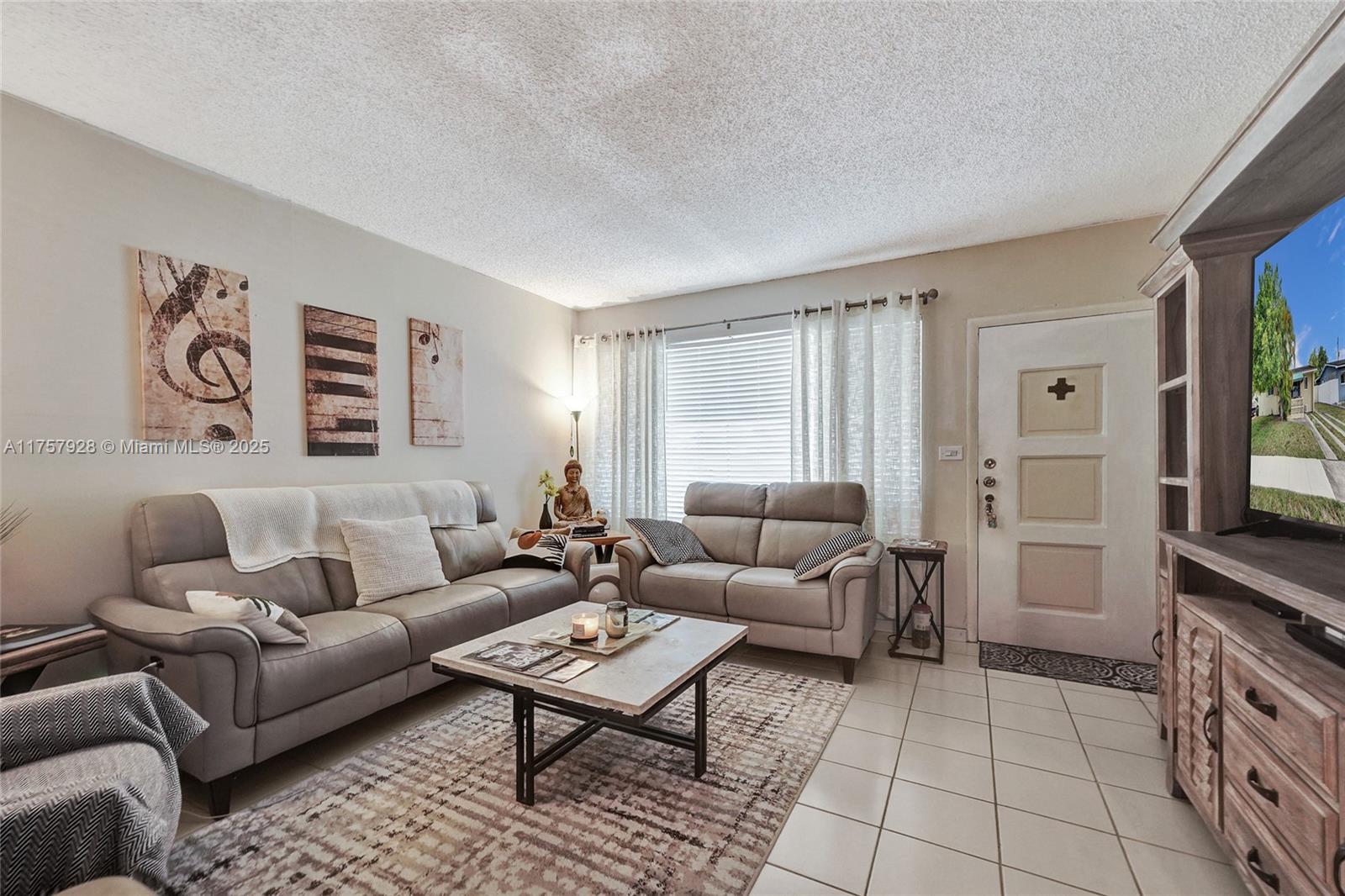 534 West 53rd Terrace Hialeah, FL 33012 - Photo 11 of 34 a living room with furniture and a flat screen tv