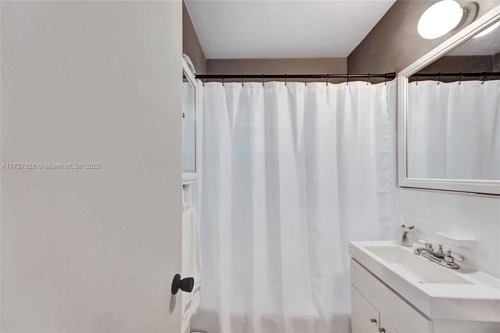 534 West 53rd Terrace Hialeah, FL 33012 - Photo 22 of 34 a bathroom with a sink and a mirror