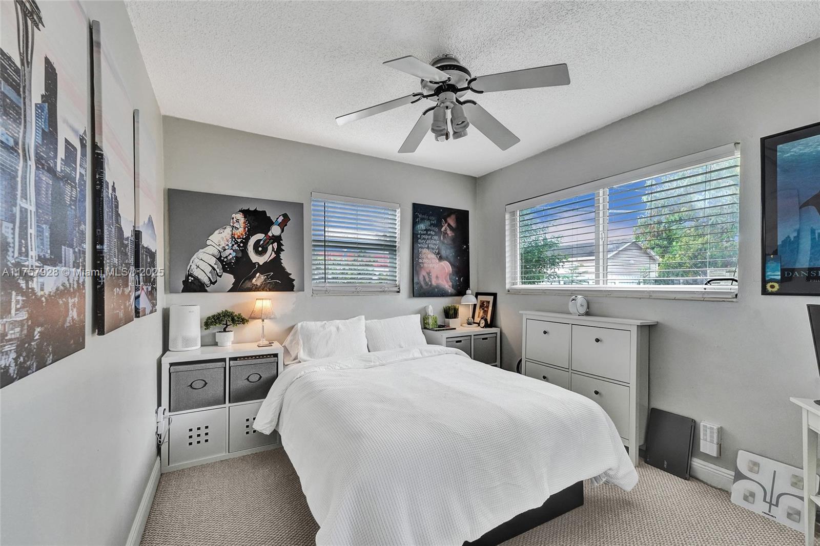 534 West 53rd Terrace Hialeah, FL 33012 - Photo 27 of 34 a bedroom with a large bed and a window