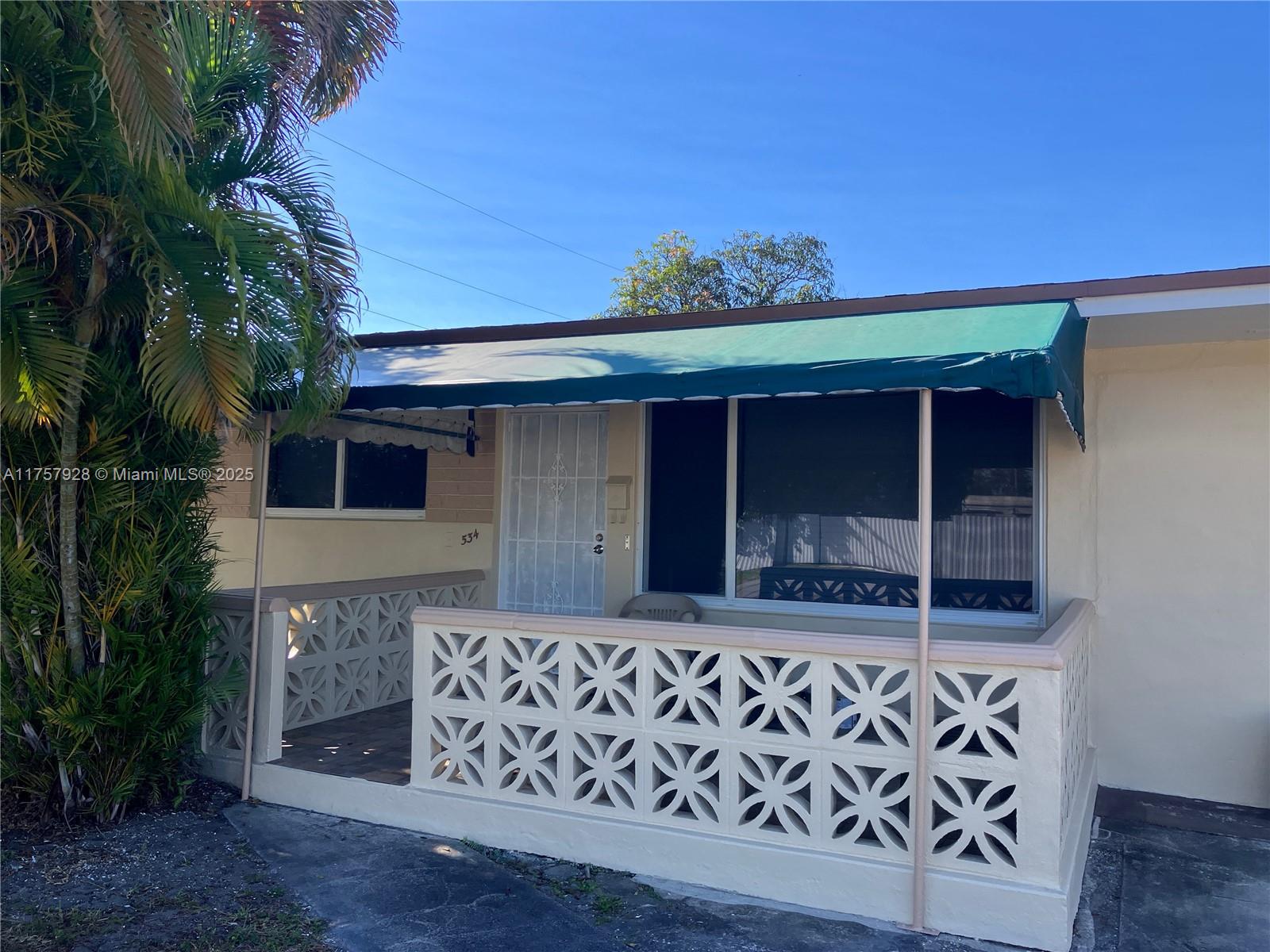 534 West 53rd Terrace Hialeah, FL 33012 - Photo 29 of 34 a front view of a house with a plants