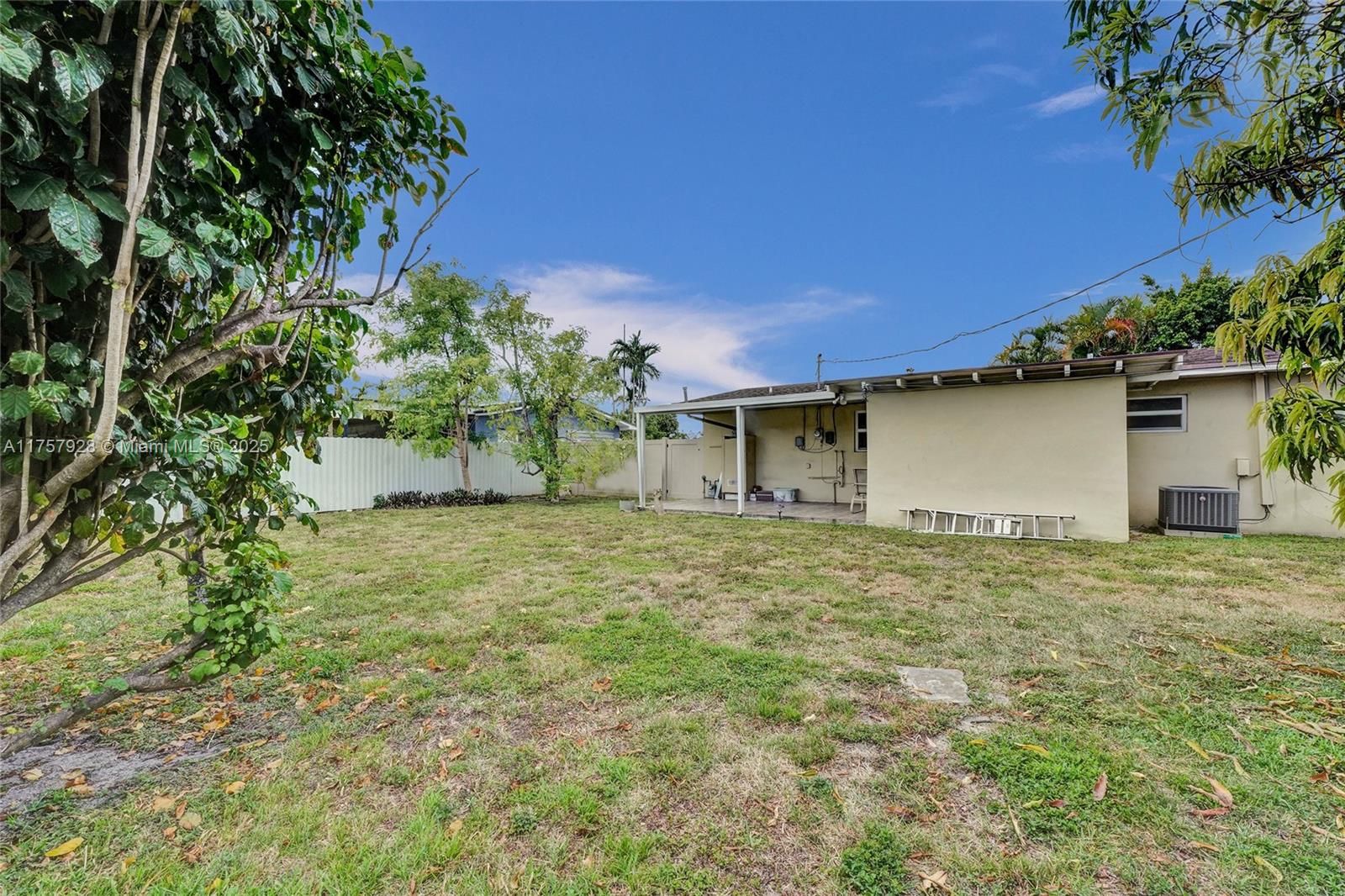 534 West 53rd Terrace Hialeah, FL 33012 - Photo 5 of 34 a backyard of a house with plants and trees