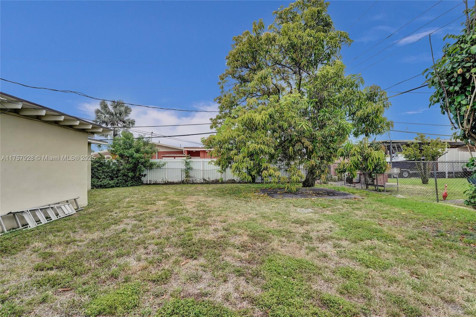 534 West 53rd Terrace Hialeah, FL 33012 - Photo 7 of 34 a backyard of a house with plants and outdoor seating