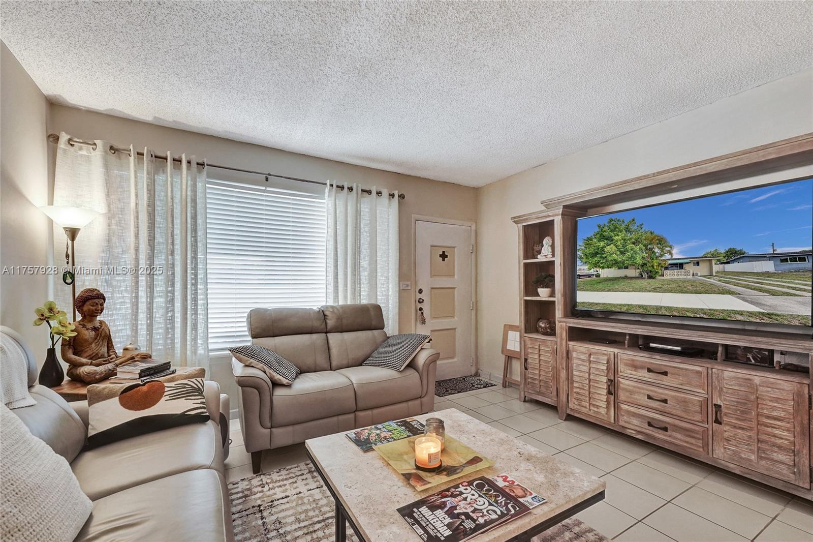 534 West 53rd Terrace Hialeah, FL 33012 - Photo 10 of 34 a living room with furniture and a flat screen tv