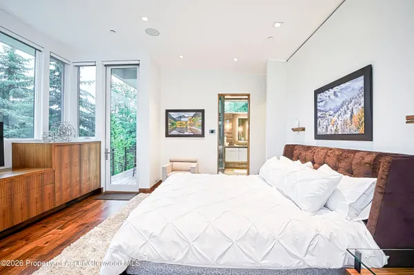 a bedroom with a large bed and a large window