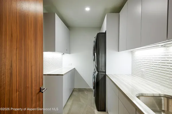 a kitchen with a sink a refrigerator and window