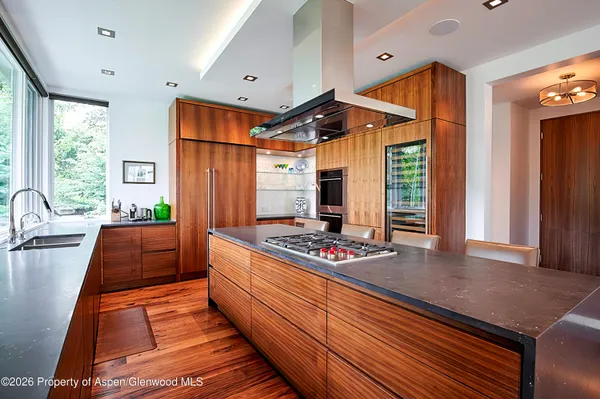 a bedroom with furniture and a large window