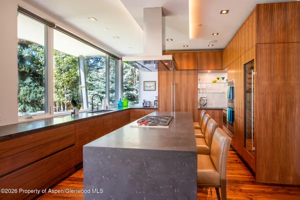 a kitchen with sink a large window and furniture