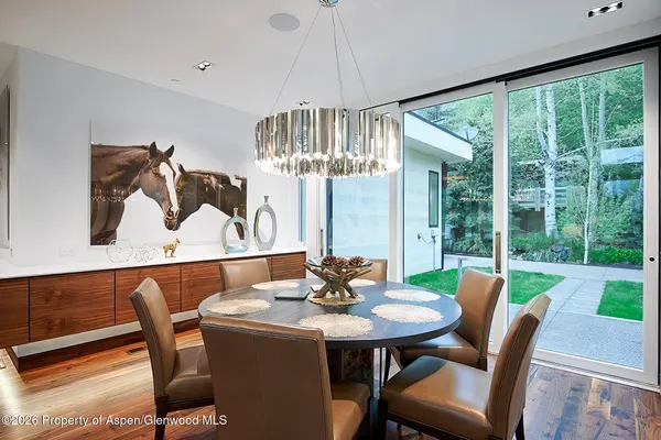 a view of a dining room with furniture wooden floor and chandelier