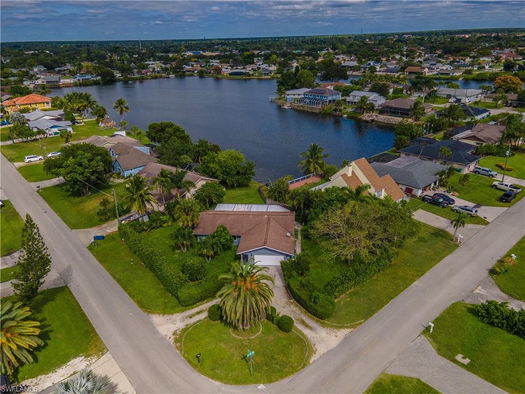 an aerial view of residential houses with outdoor space and lake view