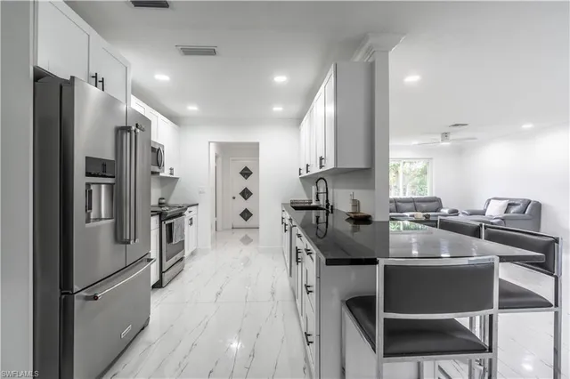 a kitchen with refrigerator cabinets and wooden floor