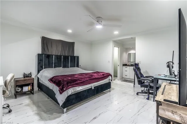 a bedroom with a bed a table and chair